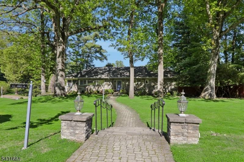 Proudly positioned on over a half acre, this stunning all stone ranch offers sweeping views from both the expansive elevated deck off the living and dining areas, and the custom ...