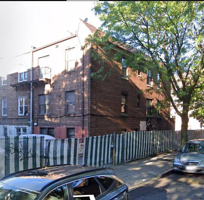 Semi detached 3 family brick home on a corner lot in the heart of Elmhurst.