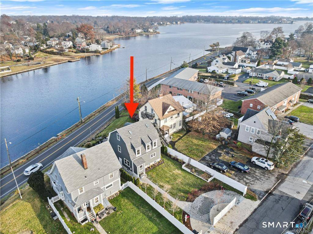 Stunning direct waterfront rental perched on a bluff overlooking Holly Pond on the Darien Stamford line.