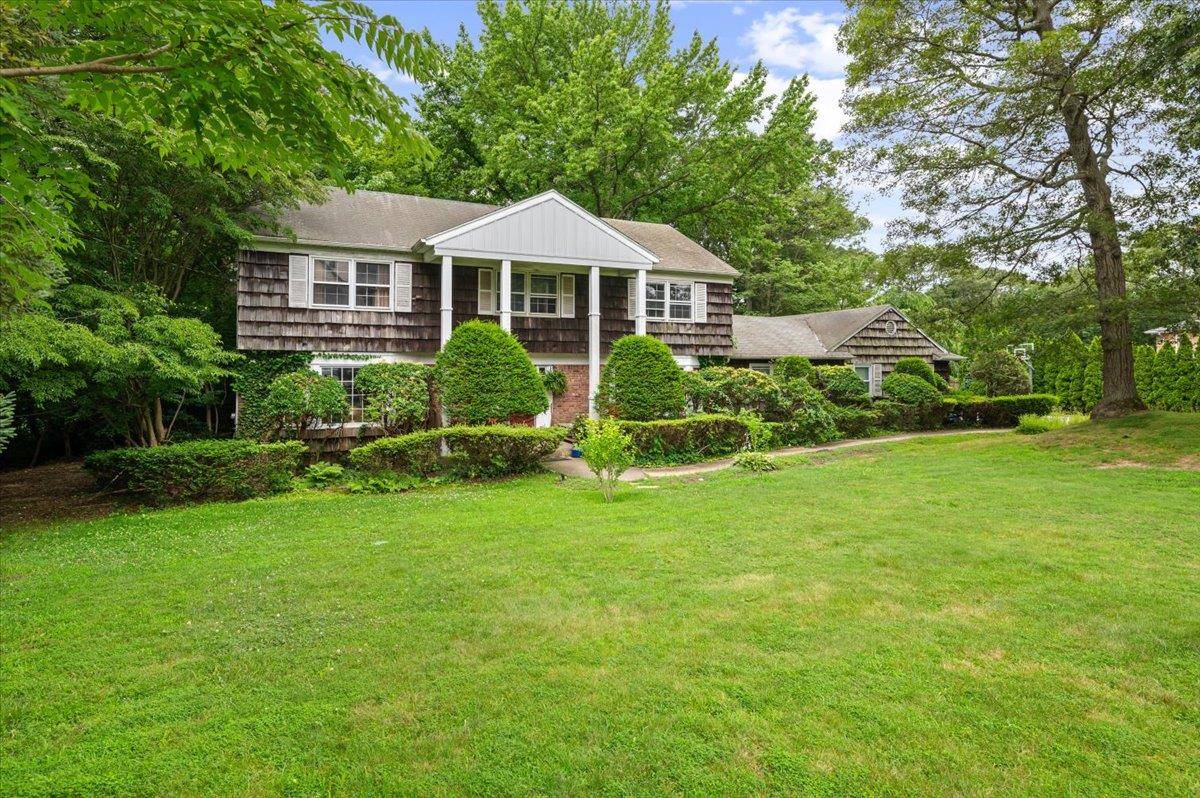 Spacious 6 Bedroom Colonial located in a prime Dix Hills setting within the Half Hollow Hills School District.