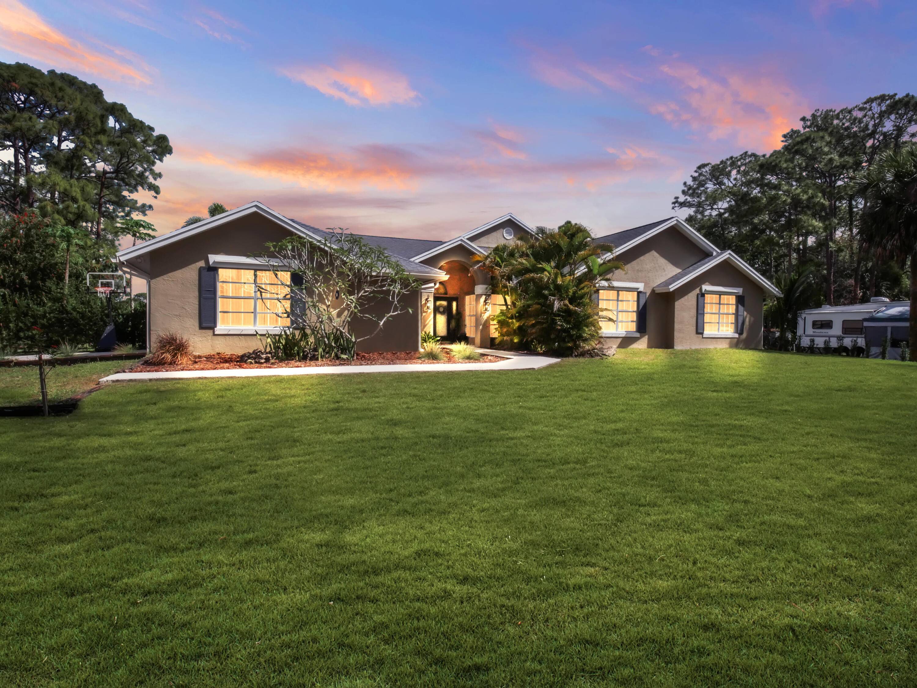 Modern 4 Bedroom, 3 Bath Home with Pool, RV Income Potential, Tropical Landscaping on 1.