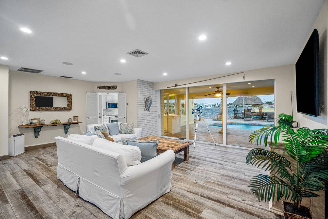 Escape to this beautifully updated tropical waterfront home, where serene water views and vibrant natural light surround you from every room.