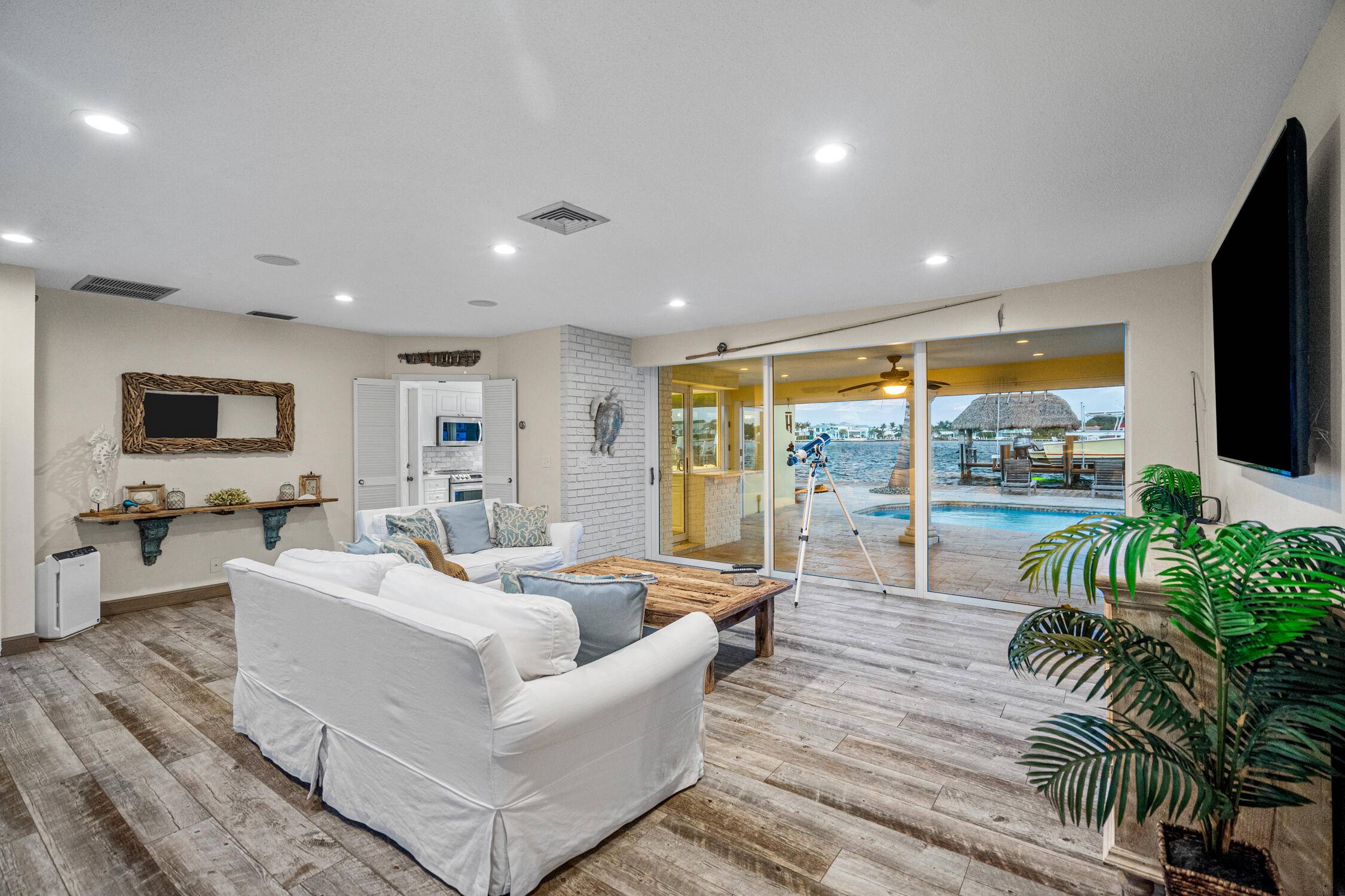 Escape to this beautifully updated tropical waterfront home, where serene water views and vibrant natural light surround you from every room.