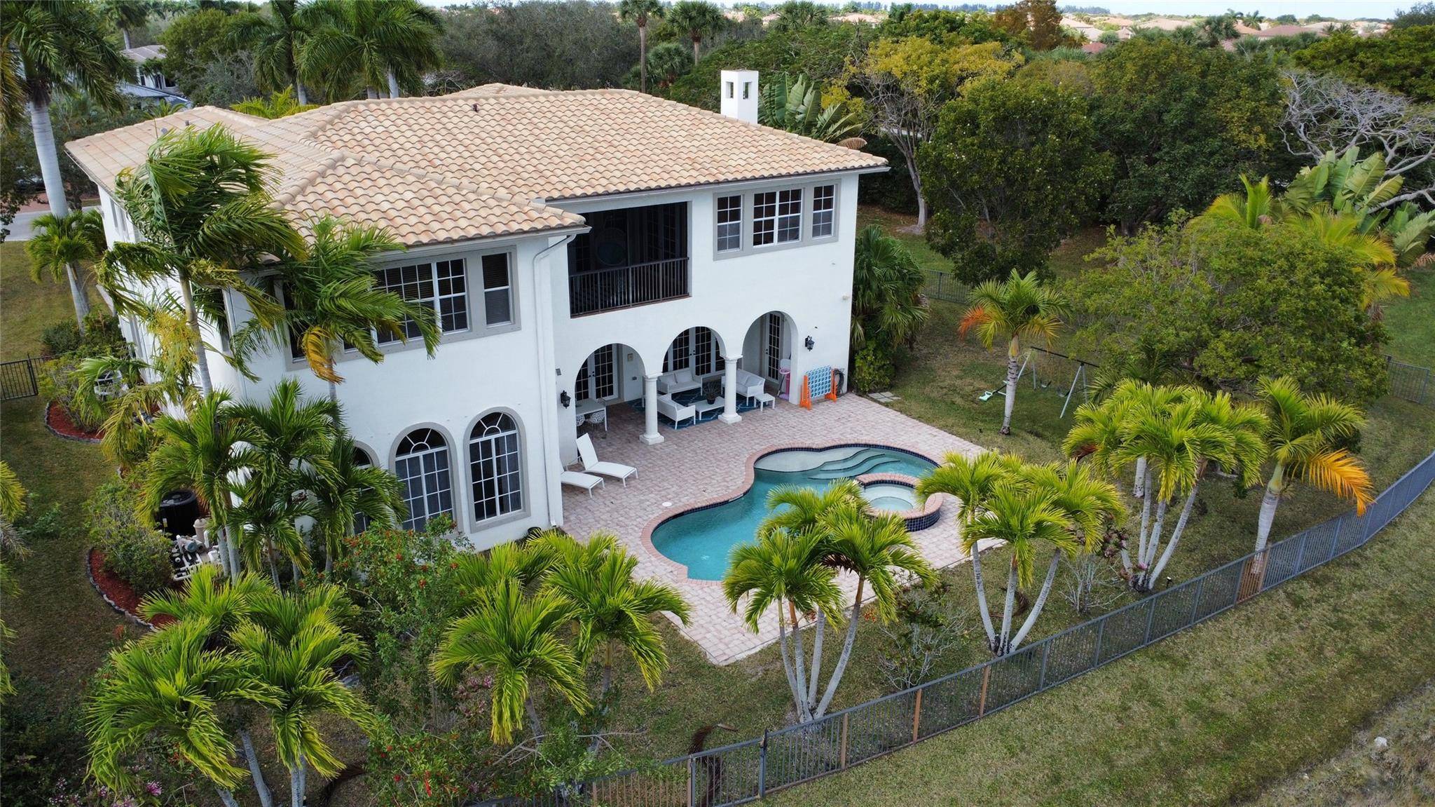 HUGE CORNER LOT ! This exceptional residence in guard gated Heron Bay community has it all and is priced to sell.