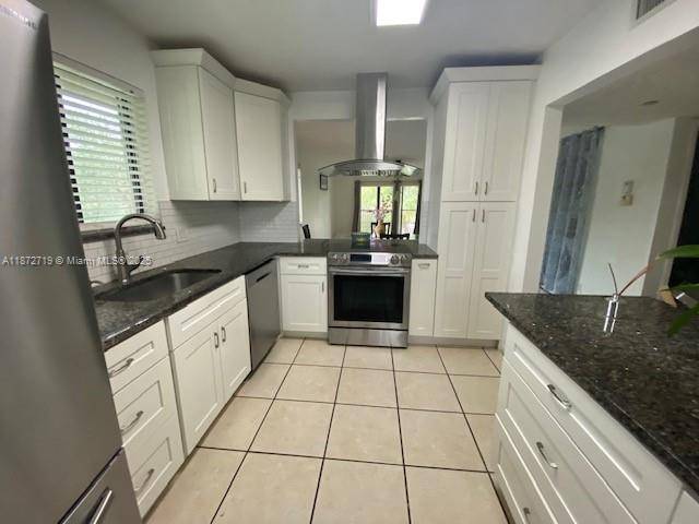 Substantially renovated 2 2 corner unit at Racquet Club in prestigious Weston where living and landscaping is upscale with a safe serene environment.