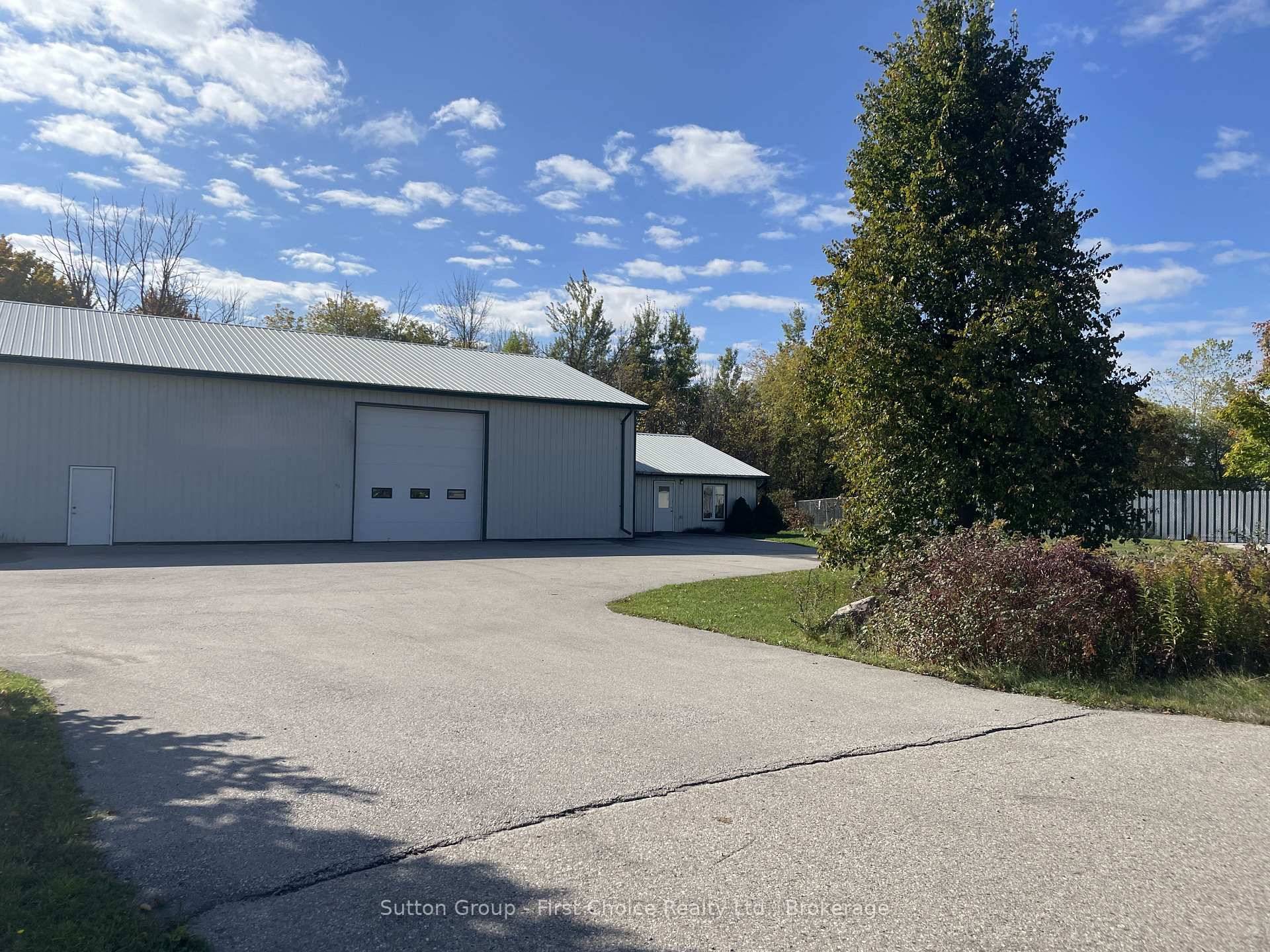 Fully insulated steel clad building with concrete floors and in floor radiant heat, featuring a 16' ceiling and a 14' x 14' overhead door.