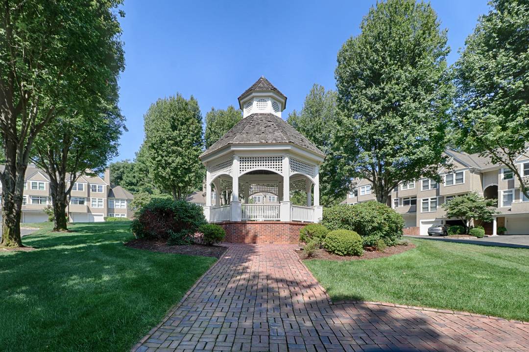 Nestled in a serene, beautifully landscaped community, this gracious townhouse at Pine Ridge offers the perfect blend of privacy and lifestyle.