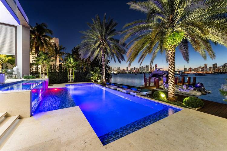 This spectacular contemporary tri level waterfront home is located on the tip of guard gated Hibiscus Island featuring a rooftop entertainment lounge amp ; the best open bay amp ; ...