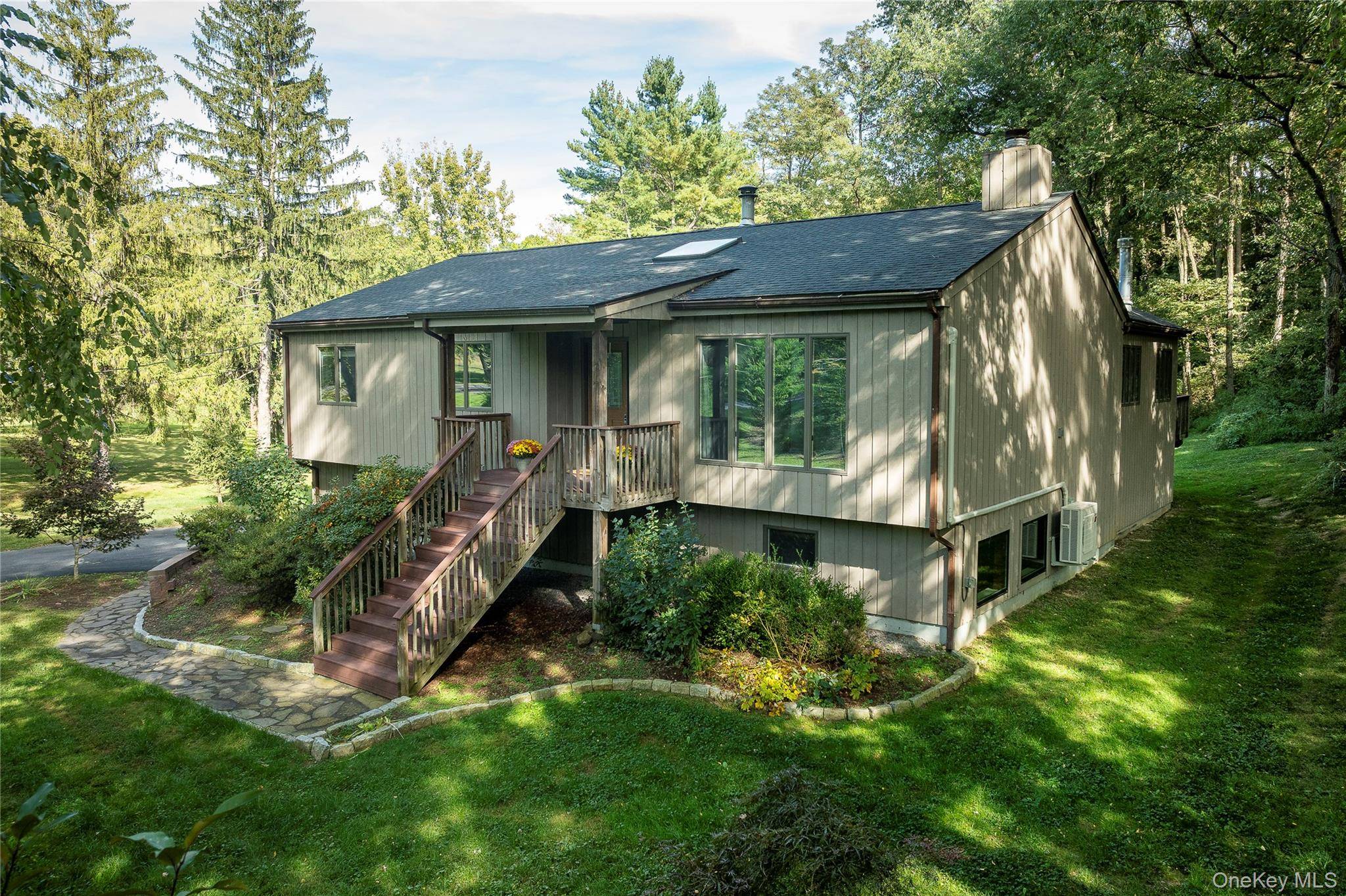 Contemporary Retreat tucked away on nearly an acre of natural beauty offers the perfect blend of modern comfort and serene country living.