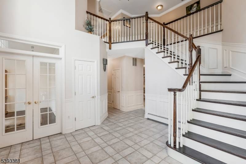 Elegant Colonial nestled on a private wooded lot combining timeless design with sun filled living spaces.