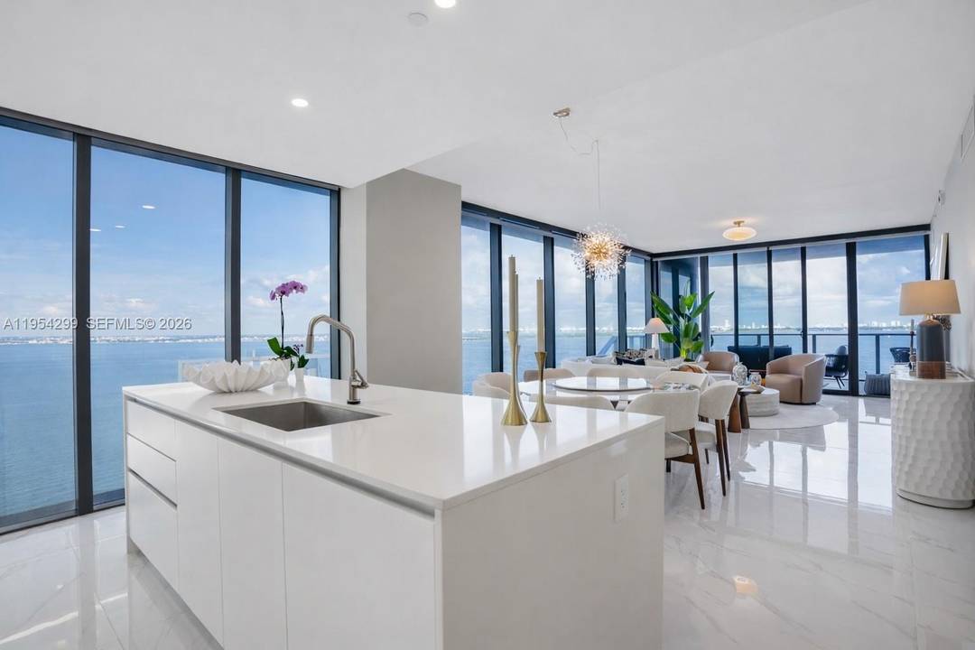 Amazing corner unit featuring four bedrooms, five full bathrooms, and one half bath at Aria Reserve, one of Miami s premier waterfront condominiums.