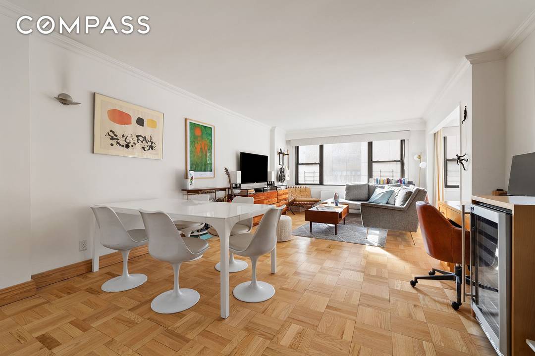 This south facing alcove studio apartment features a spacious layout with a generous living area, a dedicated dining space, a large kitchen, and a built in office nook as well ...