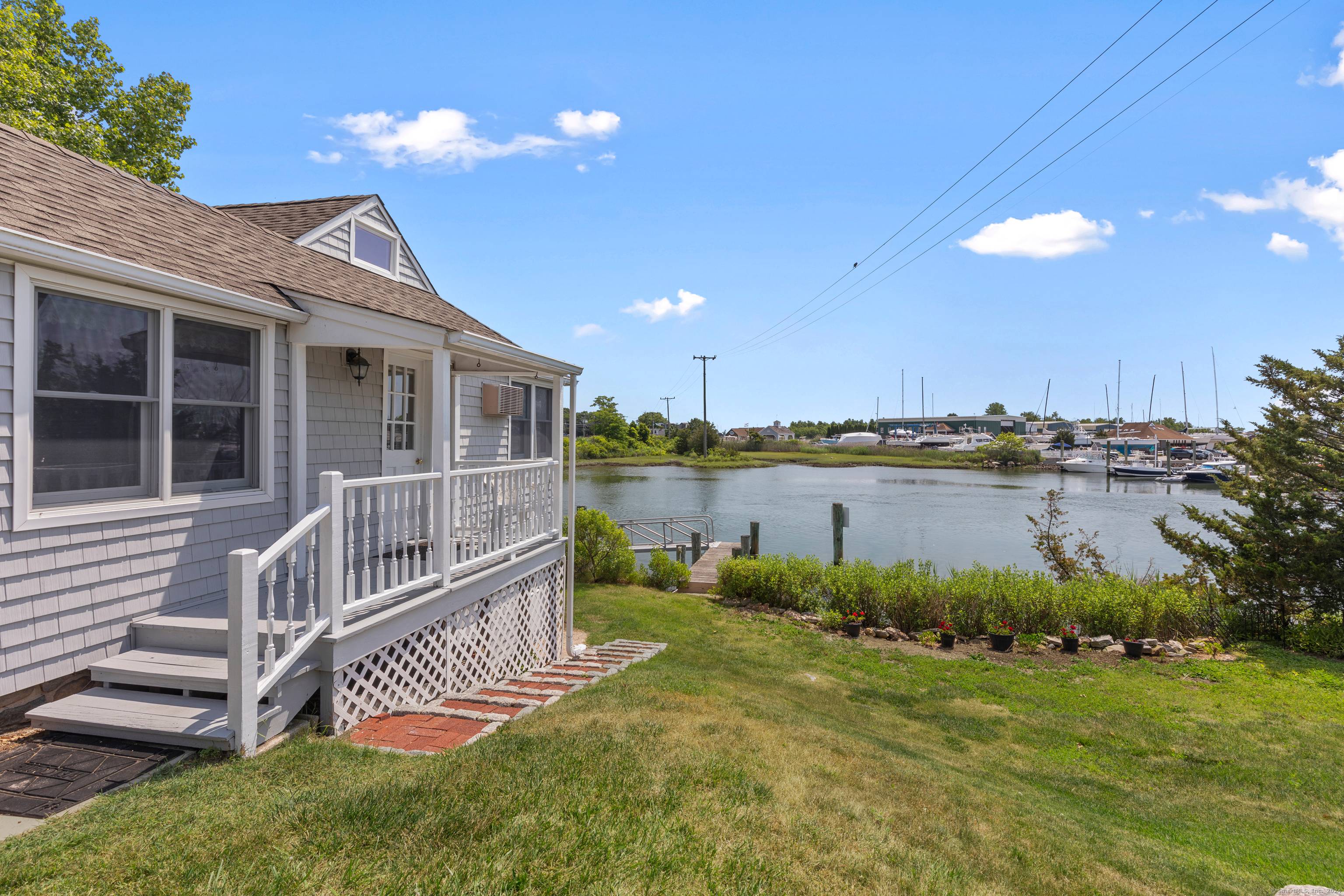 Enjoy beautiful sunrises overlooking the water with your morning coffee from the sunroom of this sweet two bedroom, two bath ranch home.
