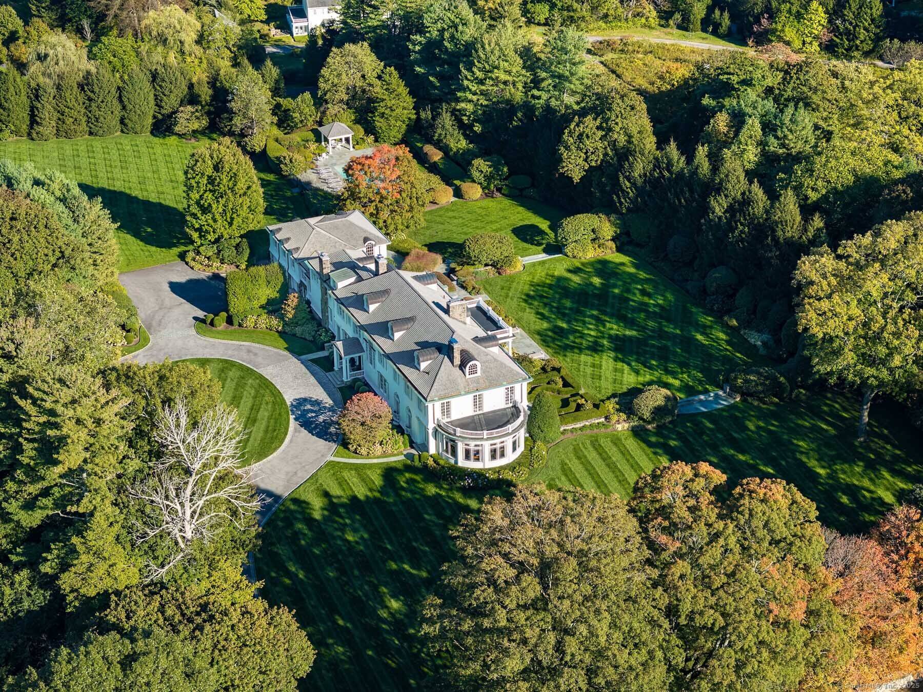 Set on one of New Canaan's highest elevations, this iconic country estate offers a rare combination of architectural distinction, modern functionality, and understated luxury.