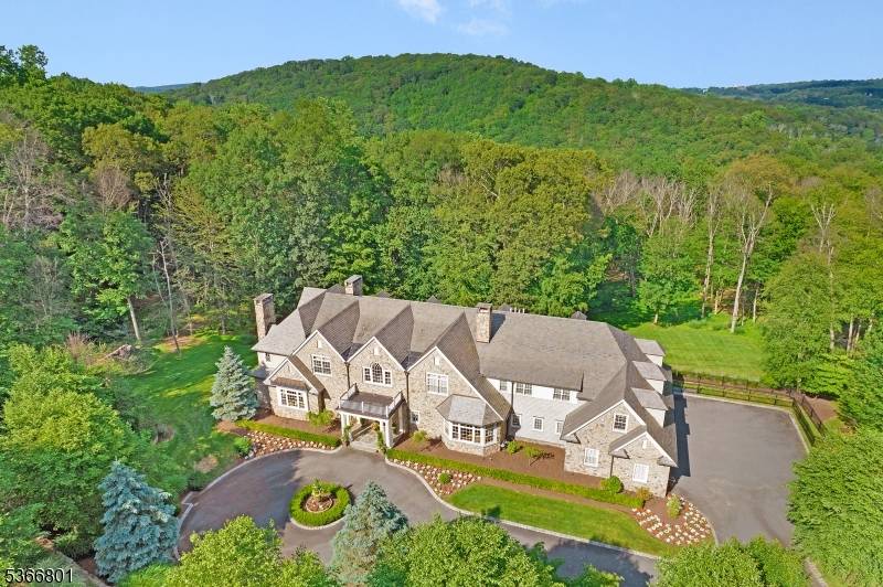 Set within Mendham's prestigious Roxiticus enclave, this extraordinary 23 acre estate offers timeless elegance, total privacy, and resort style amenities.