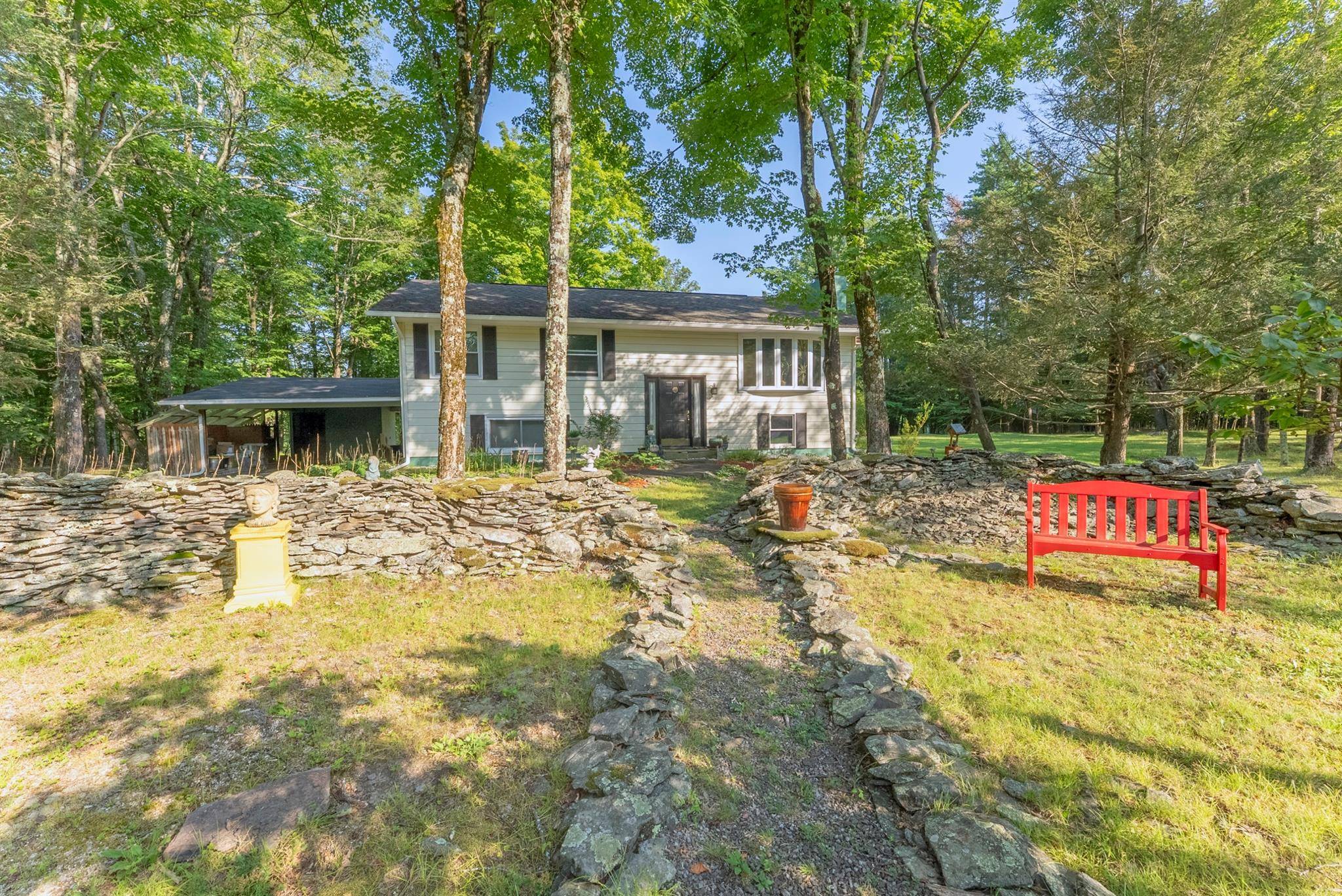 Located on a quiet, country road is this meticulously maintained raised ranch home with ample privacy.