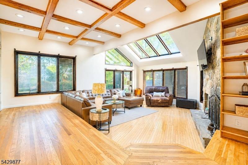 Sunlight pours through skylights and oversized windows in this unforgettable custom home filled with warmth, character, and inviting spaces at every turn.