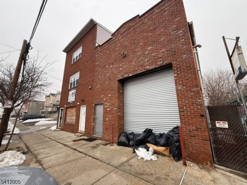 Exceptional investment opportunity featuring a 3, 500 sq ft warehouse storefront situated on a 50x100 lot.