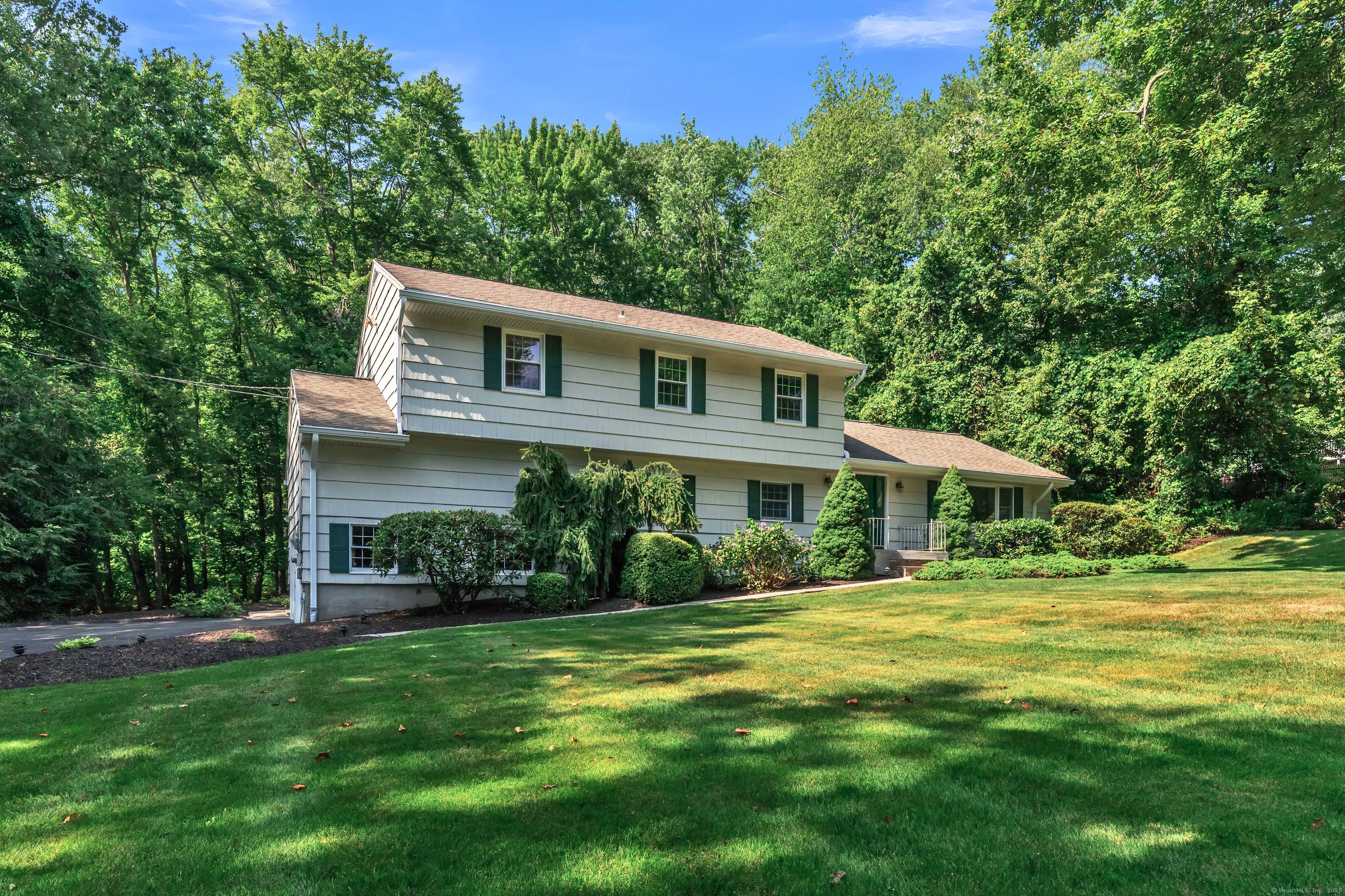 Nestled in one of Trumbull's most desirable neighborhoods, this spacious and professional landscaped home masterfully blends timeless charm with modern comfort.