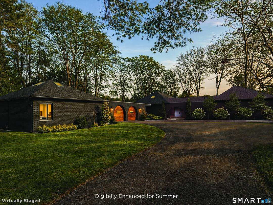 This beautifully reimagined Mid Century home sits on a picturesque stretch of the Bantam River.