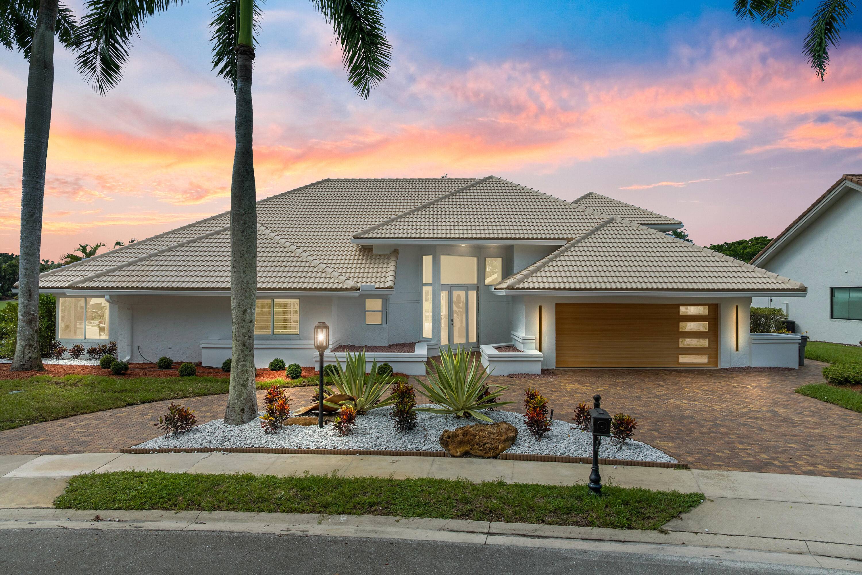 Rarely available one of a kind massive designer estate home located on a super premium lot in the country club with wide water and golf views.