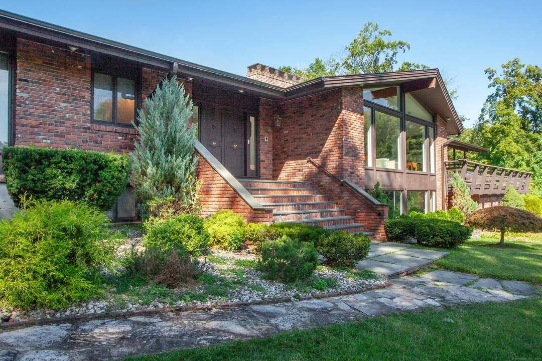 This fabulous contemporary ranch is light filled and ideally situated on an acre lot at the end of a quiet cul de sac !