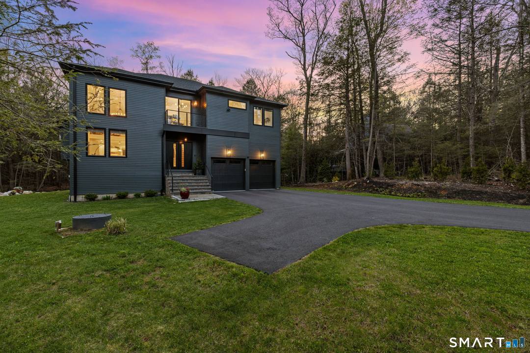 Experience the pinnacle of modern elegance in this sun soaked recent construction masterpiece thoughtfully positioned at the end of a private cul de sac in the prestigious Woodridge Lake community.