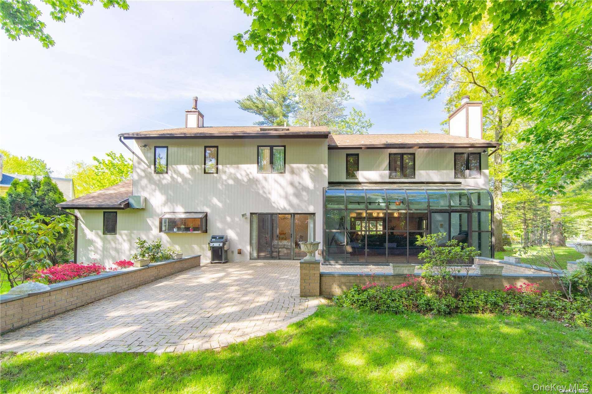Sophisticated and beautifully updated Center Hall Colonial located within the exclusive, gated community of The Hamlet Estates in North Hills.