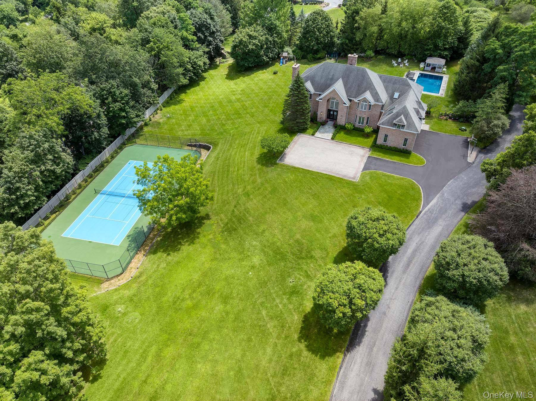 Nestled behind a gated entry on nearly three private acres in Armonk, this stately brick colonial offers a world of refined luxury and total seclusion.