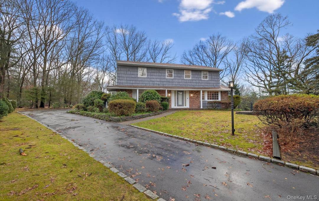Perfectly situated on a cul de sac in a prime Dix Hills location, this classic Center Hall Colonial is set on an incredible oversized property 1.