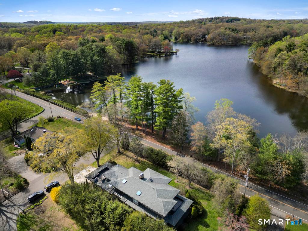 Nestled directly across from the peaceful, tree lined shores of Canoe Brook Lake, this exceptional home offers nearly 5, 000 square feet of luxurious, light filled living with lovely water ...