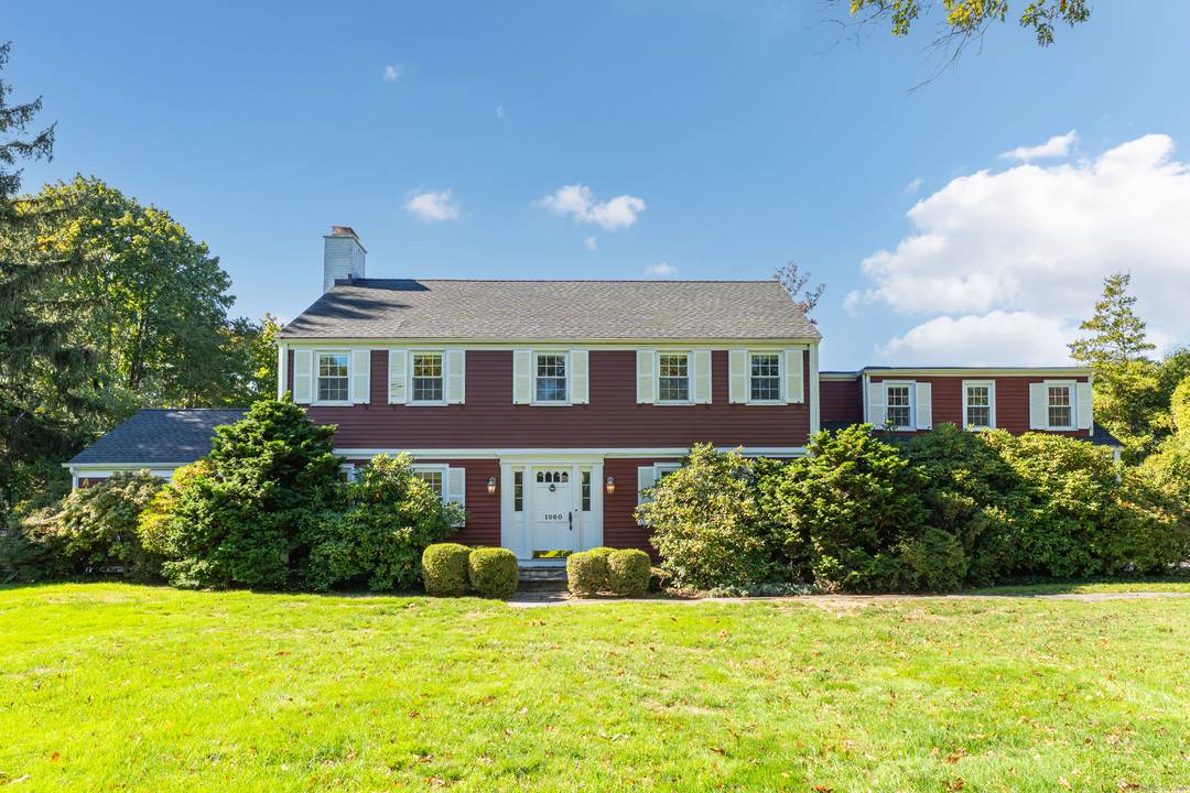 Beautifully bright and sunny Center Hall Colonial set back from the street on a beautifully landscaped 0.