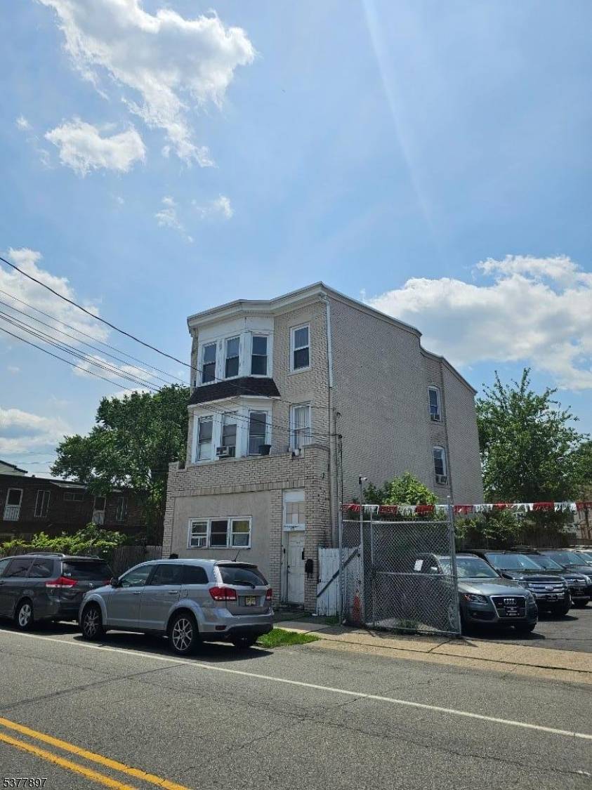 This spacious three units brick building sits on a double lot and features a 1 car garage with 2 off street parking spaces offering exceptional value and potential.