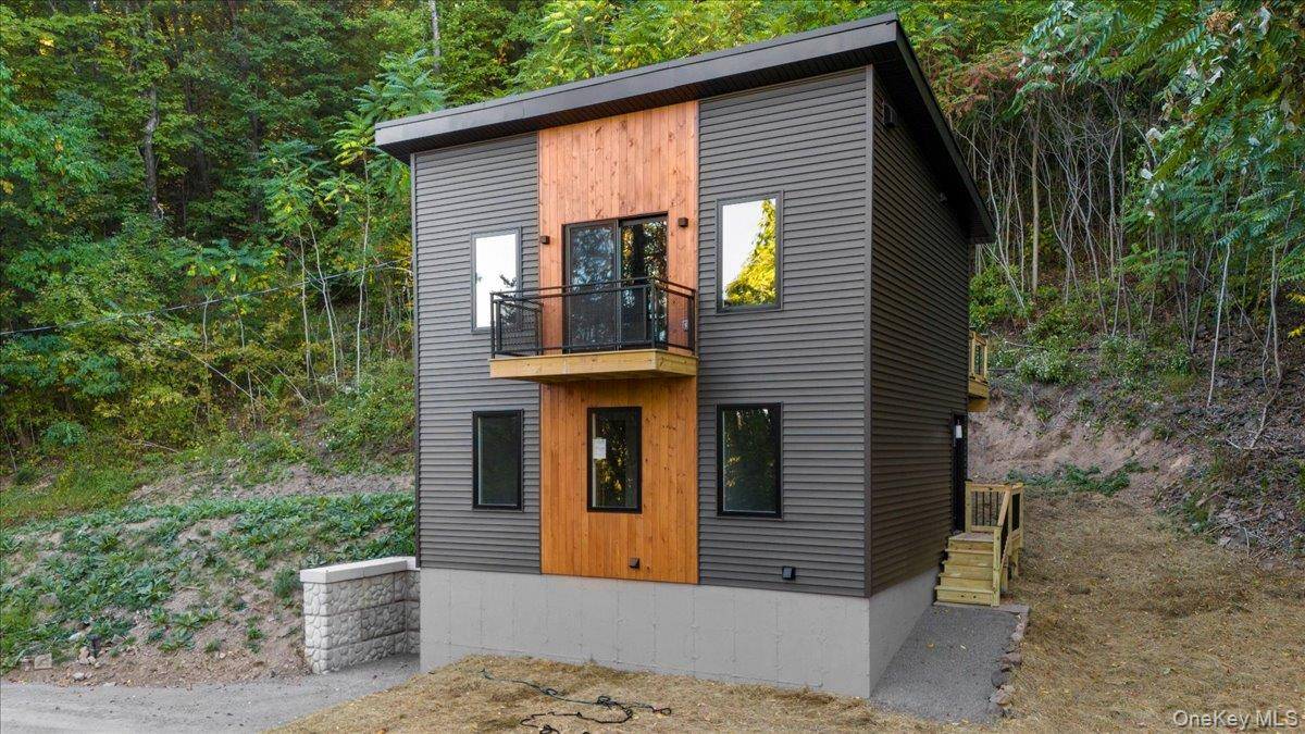 Perched along a quiet country road, this completely renovated contemporary home offers a unique layout that blends comfort, privacy, and stunning Hudson Valley surroundings.