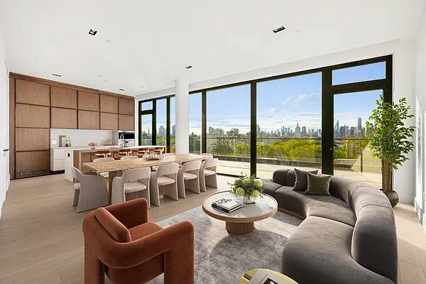 A Skyline Three Bedroom with a 605 SF Private Terrace At the center of the home is a custom Italian kitchen by LAGO, featuring veined Mario Arredo quartz countertops, Canaletto ...