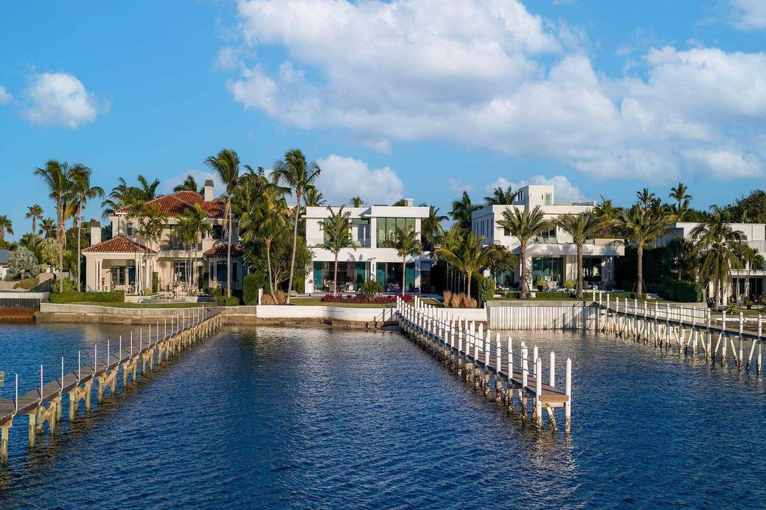 Experience refined, effortless living in this gorgeous waterfront estate in the private enclave of Hypoluxo Island.