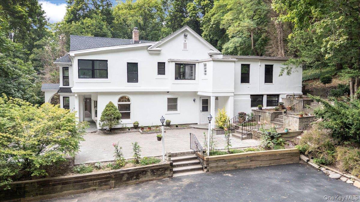 Discover a rare opportunity to own a beautifully updated estate in the prestigious Village of Muttontown.