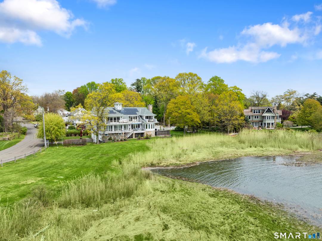Located in Stamford's Cove neighborhood, this exceptional waterfront residence combines striking architecture, high end construction, and sweeping water views from nearly every room.