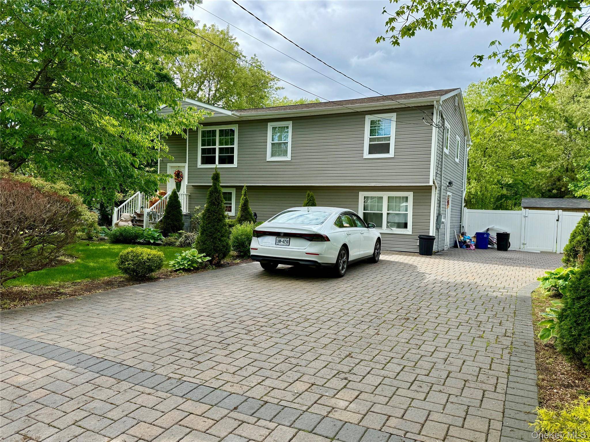 Welcome to 243 Sea Cliff Street, a spacious Hi Ranch home nestled in the heart of Islip Terrace.