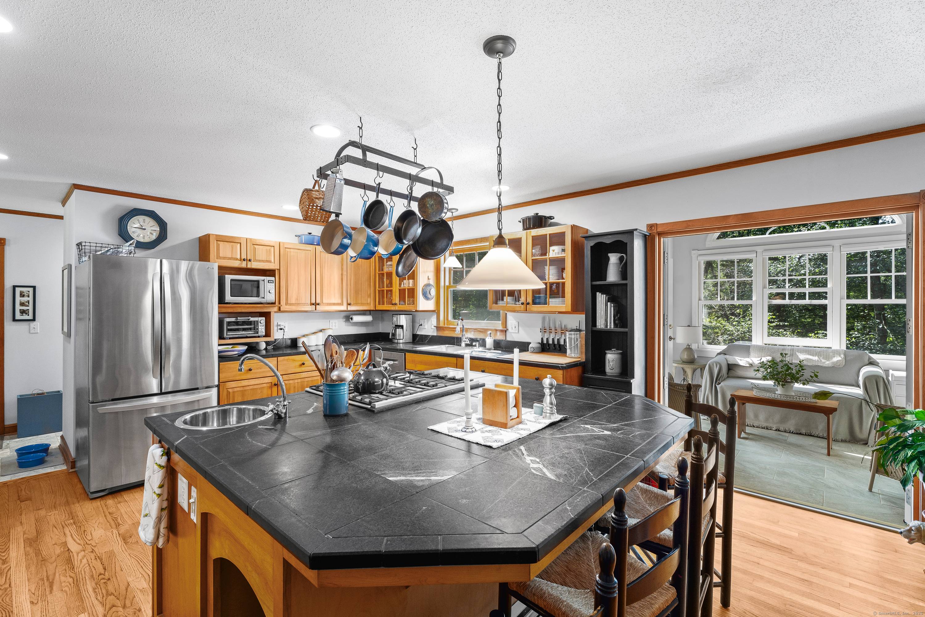 Nestled at the beginning of a quiet cul de sac and surrounded by mature trees and classic stone walls, this beautifully maintained 3 bedroom, 2.