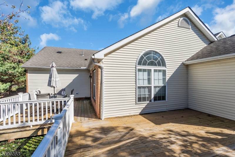 55 at its finest ! Welcome home to this rare end unit with a two car garage and two spacious decks overlooking beautifully landscaped green space.