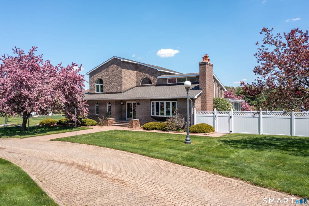 Welcome to this exceptional, custom built brick home, set on a stunning piece of property where quality, craftsmanship, and timeless design come together beautifully.