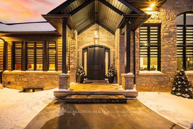 Experience unparalleled privacy and luxury in this stunning custom built bungalow, nestled on 10 beautifully treed acres and accessed through secure electronic gates.