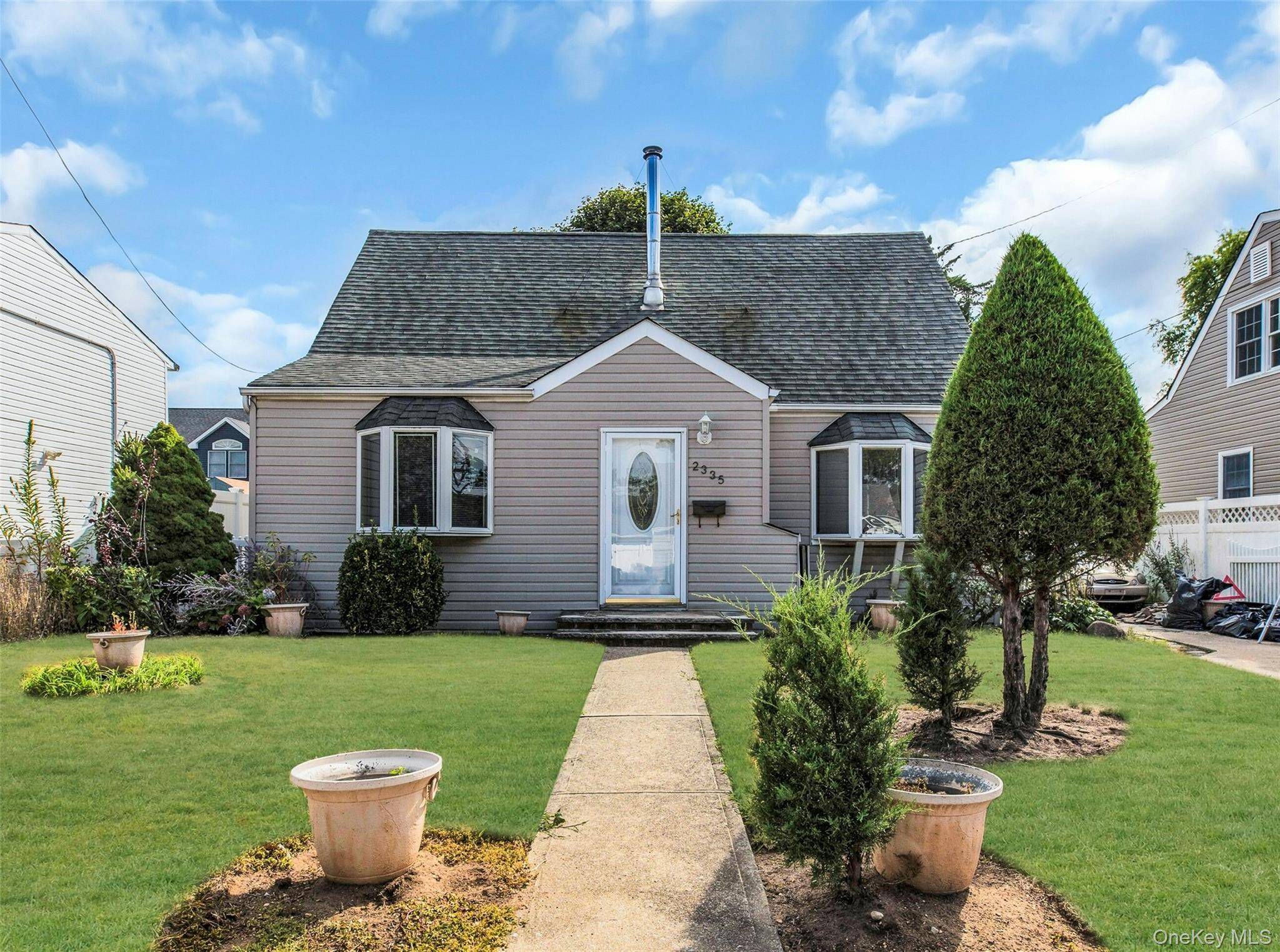 NEW ENGLAND CAPE COD HOME WITH REAR DORMER.