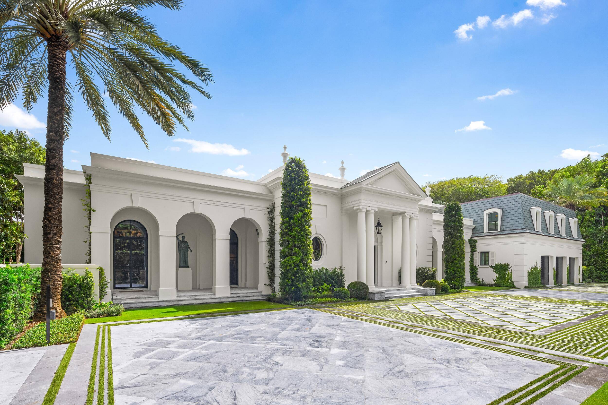 Encompassing almost an acre of prime Palm Beach real estate on Billionaires Row, 1230 S Ocean Blvd.