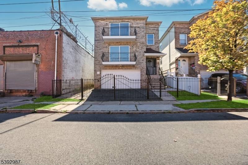 Welcome to 13 Wharton Street, a spacious and modern three family home located in the heart of Newark.