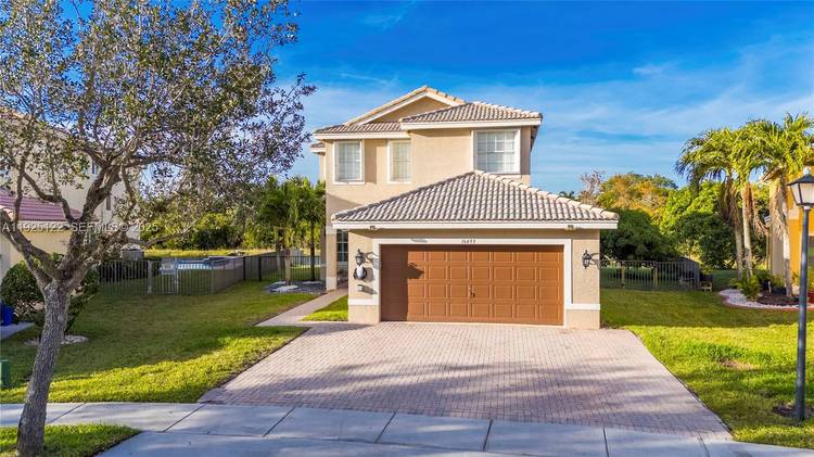 Welcome to one of the most private lakefront homes in West Miramar, located in the gated community of Silver Isles.
