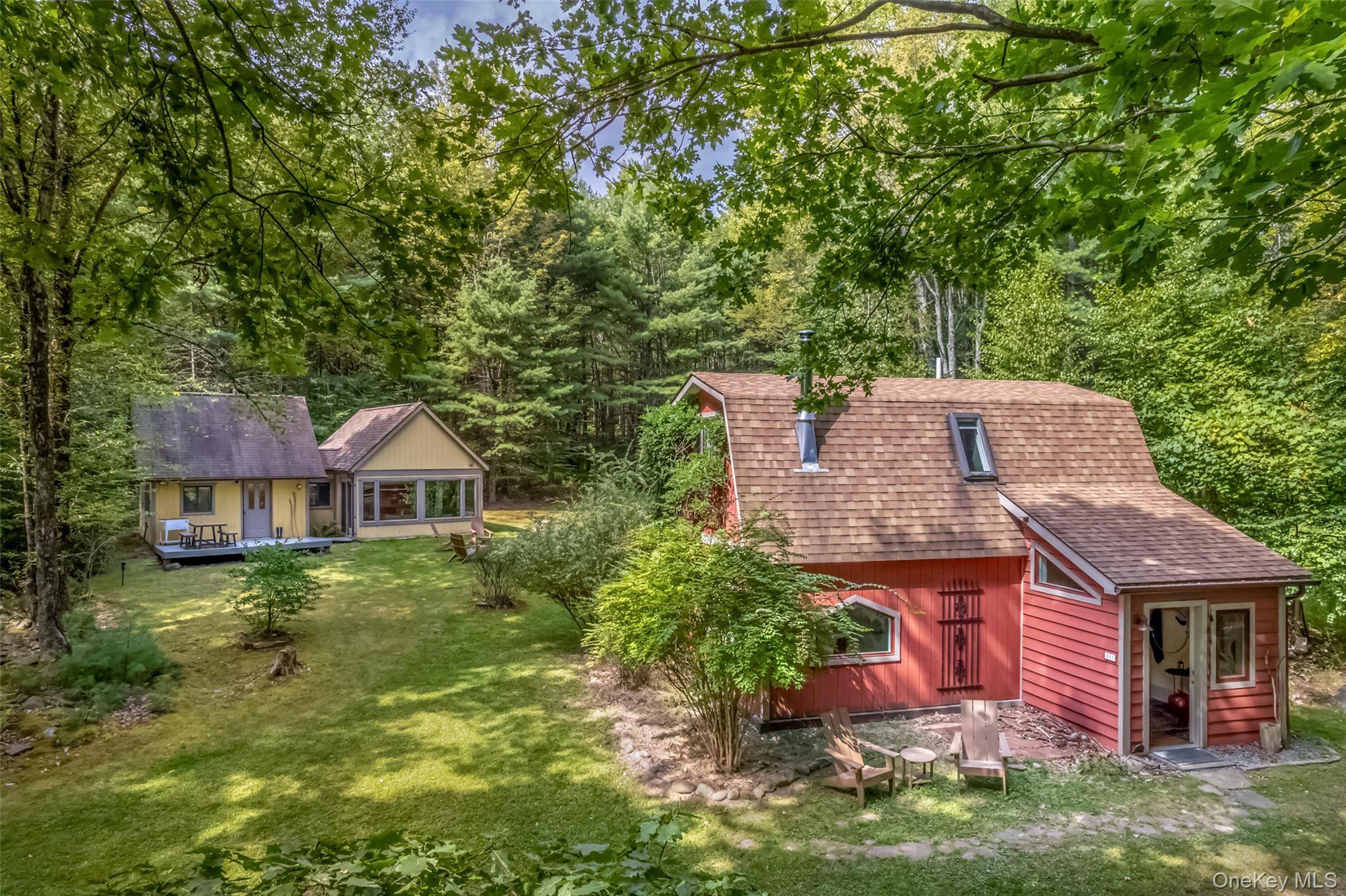 Privately sited on 10 acres, this peaceful retreat is defined by its meandering nature trails, quiet meadows, and a serene pond where turtles bask on the banks and wildlife drifts ...