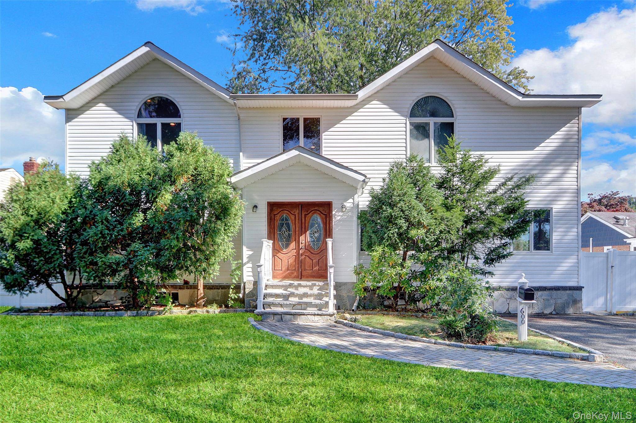 Welcome to this expansive open concept Colonial in the heart of Plainview.