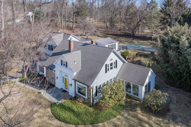 Set within Bernardsville's coveted On The Mountain enclave, this extraordinary residence is a rare offering steeped in architectural history and timeless charm.